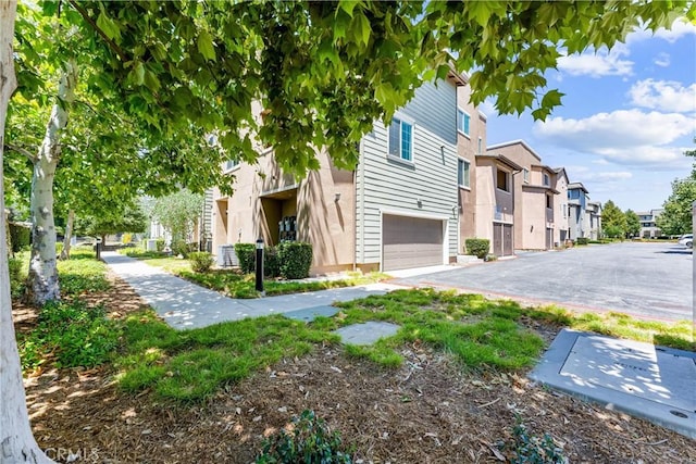 1166 Newberry Ln Unit 1, Claremont, CA 91711 - view of side of home featuring a residential view, a garage, and asphalt driveway