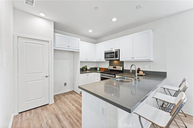 1166 Newberry Ln Unit 1, Claremont, CA 91711 - kitchen with stainless steel appliances, white cabinets, light wood finished floors, and recessed lighting
