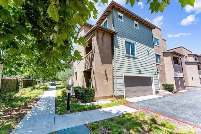 1166 Newberry Ln Unit 1, Claremont, CA 91711 - view of side of home featuring an attached garage and driveway