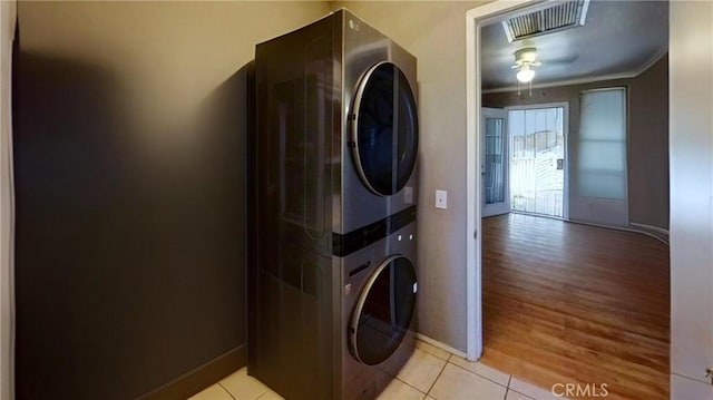 5772 Arrowhead Lake Rd, Hesperia, CA 92345 - laundry area with stacked washer / dryer, crown molding, and light wood finished floors