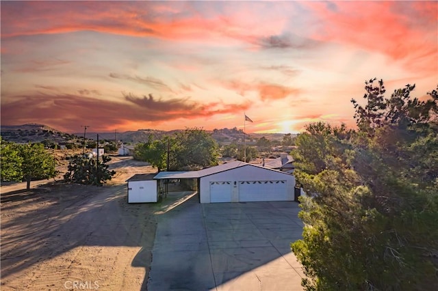 5772 Arrowhead Lake Rd, Hesperia, CA 92345 - view of front of property featuring driveway, a carport, an outdoor structure, and a mountain view