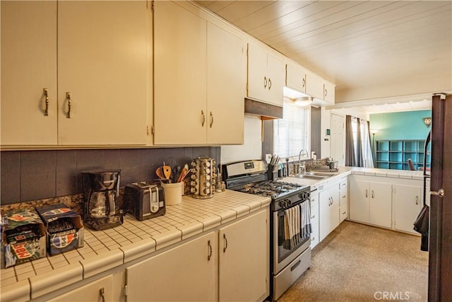 5772 Arrowhead Lake Rd, Hesperia, CA 92345 - kitchen with stainless steel gas stove, tile countertops, light colored carpet, white cabinets, and backsplash