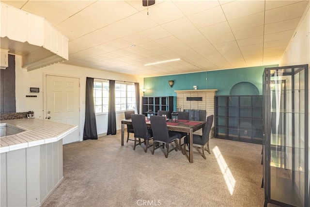 5772 Arrowhead Lake Rd, Hesperia, CA 92345 - dining room featuring light colored carpet and a fireplace