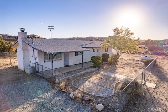 5772 Arrowhead Lake Rd, Hesperia, CA 92345 - back of property with a chimney, a patio area, and stucco siding