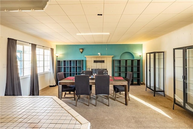 5772 Arrowhead Lake Rd, Hesperia, CA 92345 - dining area with carpet floors and a brick fireplace