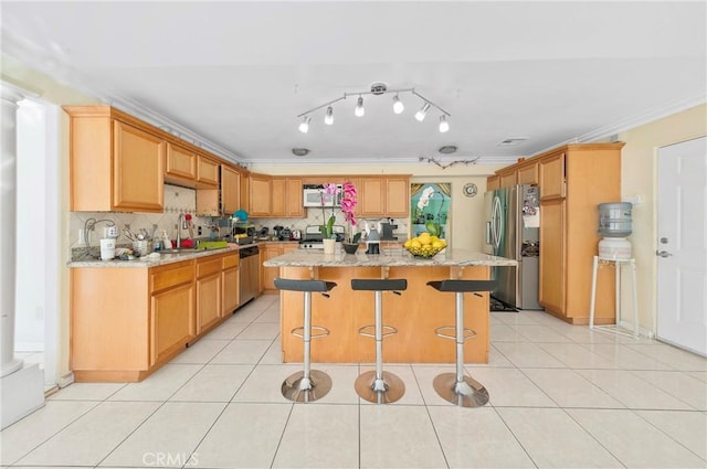1740 Rada Rd, Hacienda Heights, CA 91745 - kitchen with stainless steel appliances, a breakfast bar area, decorative backsplash, ornamental molding, and light stone counters