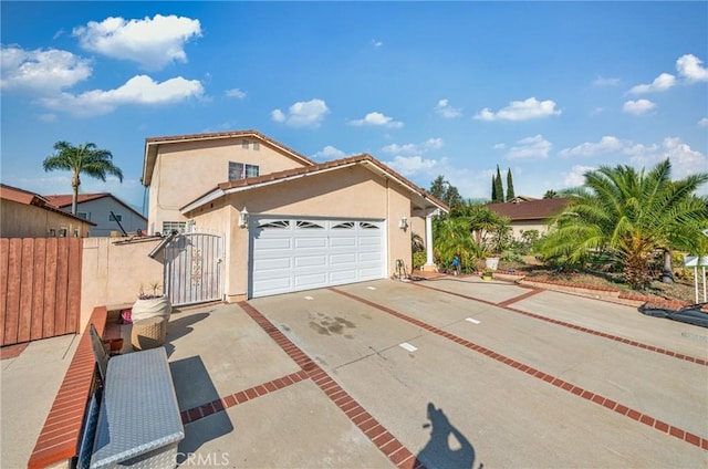 1740 Rada Rd, Hacienda Heights, CA 91745 - mediterranean / spanish house with stucco siding, driveway, a garage, and a gate