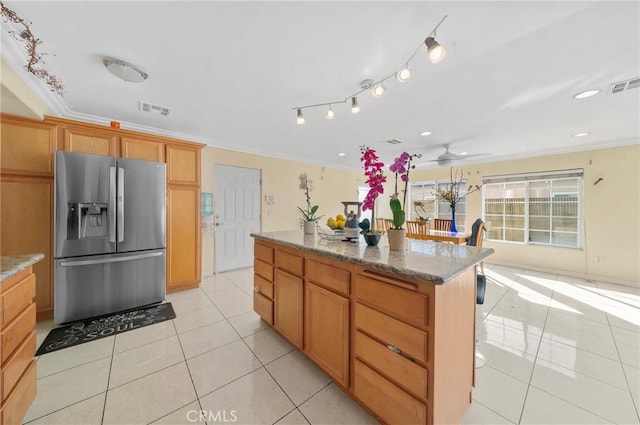 1740 Rada Rd, Hacienda Heights, CA 91745 - kitchen with stainless steel fridge, crown molding, light tile patterned flooring, light stone counters, and a center island