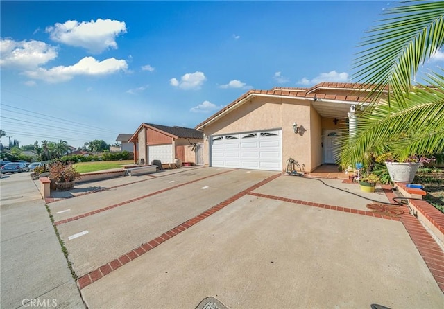 1740 Rada Rd, Hacienda Heights, CA 91745 - view of front of house featuring stucco siding, concrete driveway, a garage, and a tile roof
