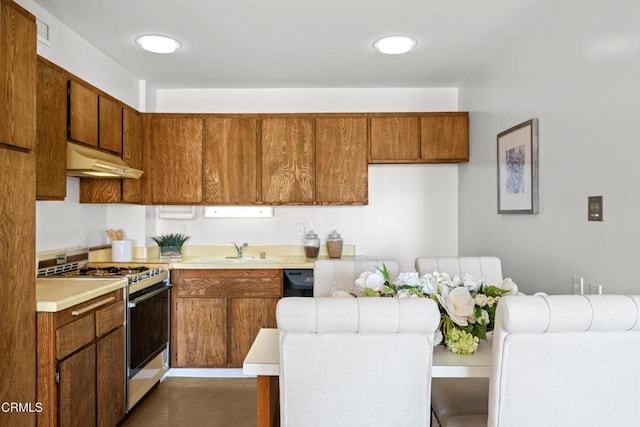 800 W 1st St Unit 1701, Los Angeles, CA 90012 - kitchen featuring gas range gas stove, light countertops, under cabinet range hood, and brown cabinets