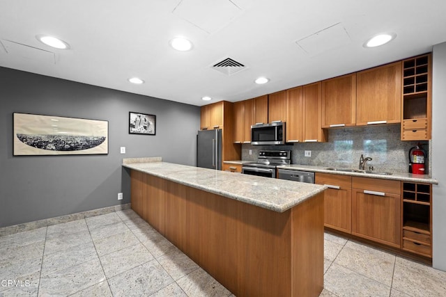 800 W 1st St Unit 1701, Los Angeles, CA 90012 - kitchen with open shelves, a peninsula, appliances with stainless steel finishes, tasteful backsplash, and brown cabinets