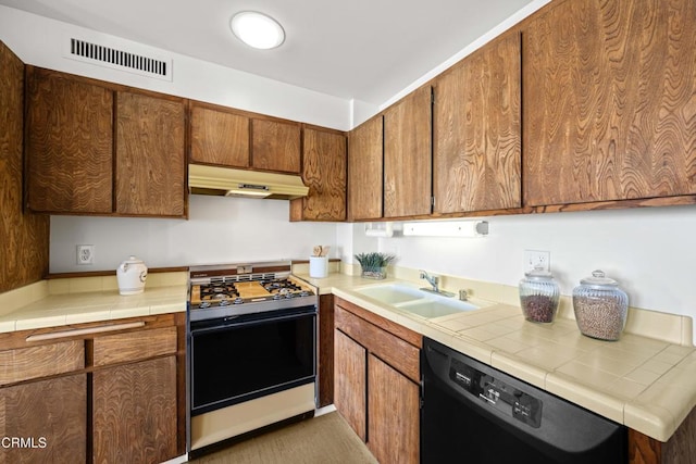 800 W 1st St Unit 1701, Los Angeles, CA 90012 - kitchen with gas range, dishwasher, under cabinet range hood, and tile countertops