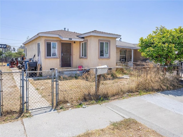 13114 S Main St, Los Angeles, CA 90061 - bungalow featuring a gate, a fenced front yard, and stucco siding