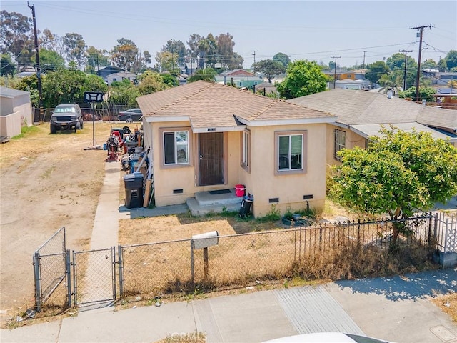 13114 S Main St, Los Angeles, CA 90061 - bungalow with crawl space, a gate, stucco siding, and a shingled roof