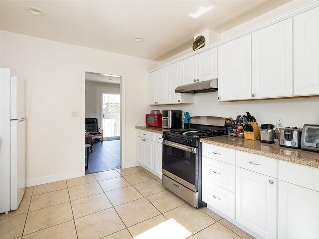 1735 257th St, Lomita, CA 90717 - kitchen featuring gas stove, freestanding refrigerator, under cabinet range hood, white cabinets, and light tile patterned floors
