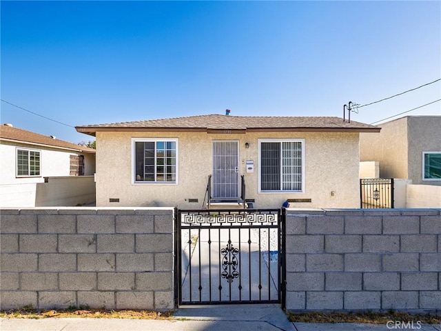 1735 257th St, Lomita, CA 90717 - view of front facade featuring a fenced front yard, stucco siding, and a gate