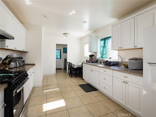 1735 257th St, Lomita, CA 90717 - kitchen featuring stainless steel gas range, white cabinets, plenty of natural light, light tile patterned flooring, and recessed lighting