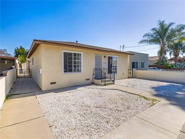 1735 257th St, Lomita, CA 90717 - rear view of house featuring stucco siding, crawl space, a patio area, and a gate