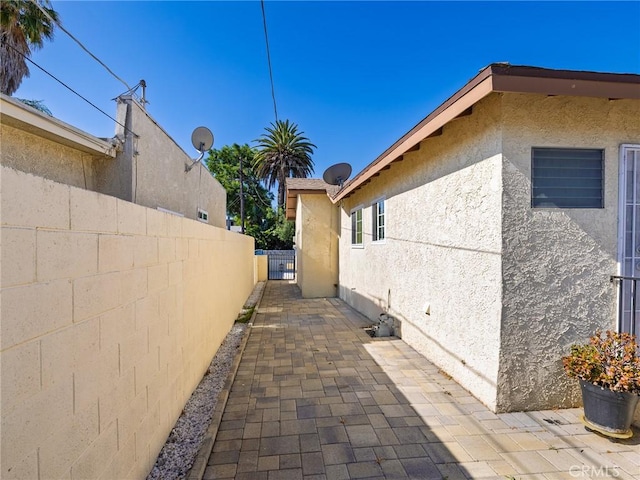 1735 257th St, Lomita, CA 90717 - view of side of home with stucco siding and a patio