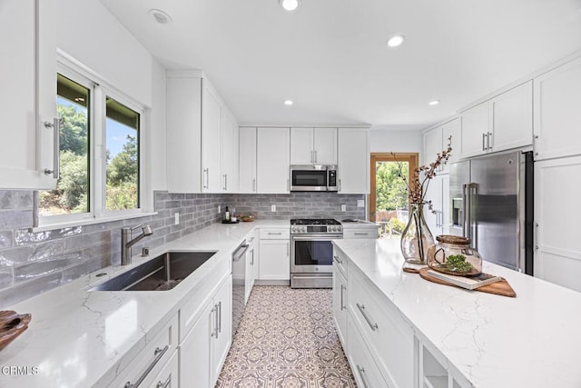 4520 Lone Pine Ln, La Canada Flintridge, CA 91011 - kitchen with premium appliances, recessed lighting, white cabinets, light stone counters, and decorative backsplash