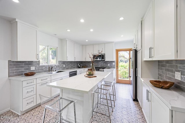 4520 Lone Pine Ln, La Canada Flintridge, CA 91011 - kitchen featuring stainless steel appliances, healthy amount of natural light, a kitchen bar, backsplash, and recessed lighting