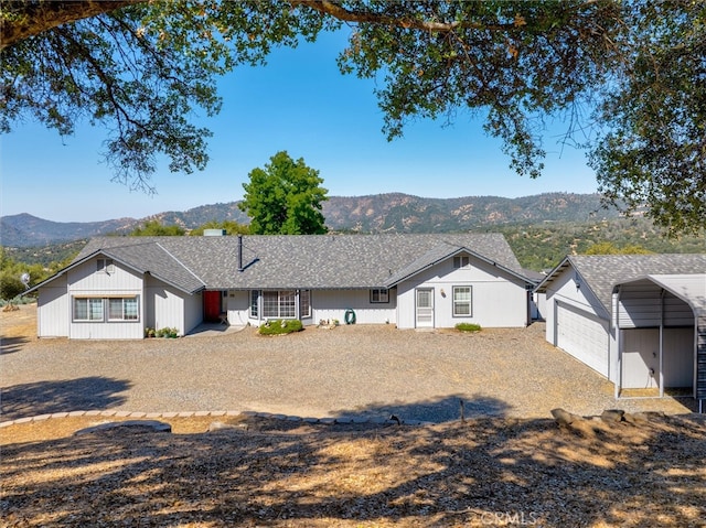 45337 Valley Oak Dr, Ahwahnee, CA 93601 - ranch-style house with a garage, a mountain view, a shingled roof, and driveway