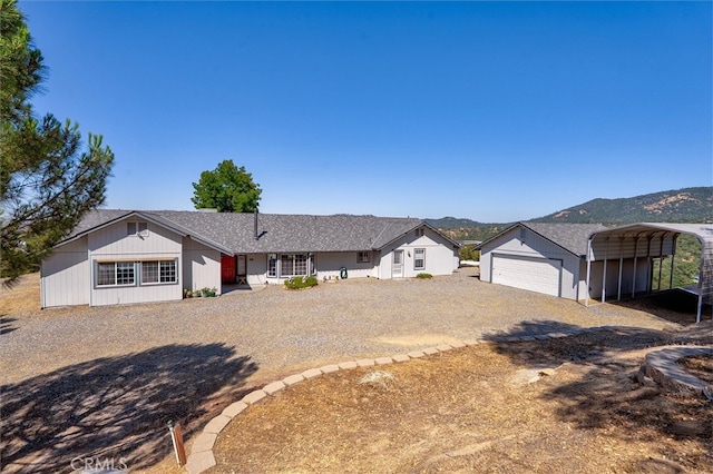45337 Valley Oak Dr, Ahwahnee, CA 93601 - ranch-style house with driveway, a carport, a mountain view, and an outbuilding