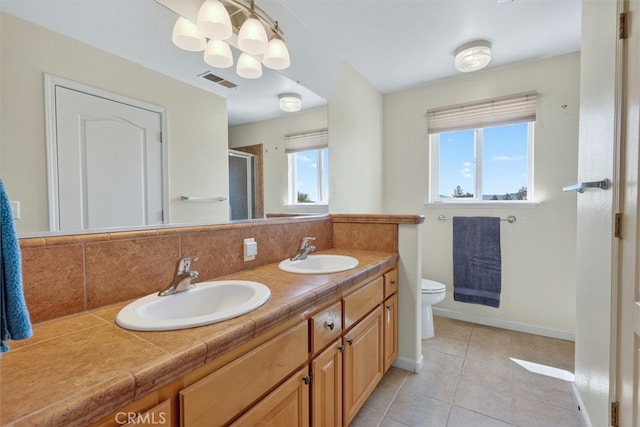 45337 Valley Oak Dr, Ahwahnee, CA 93601 - bathroom featuring a shower stall, tile patterned flooring, double vanity, decorative backsplash, and a chandelier