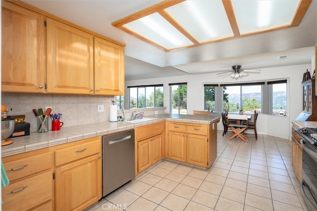 45337 Valley Oak Dr, Ahwahnee, CA 93601 - kitchen with appliances with stainless steel finishes, light tile patterned floors, plenty of natural light, and a peninsula