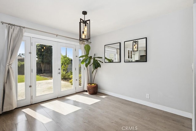 3314 Benton Ave, La Verne, CA 91750 - unfurnished dining area featuring french doors, wood finished floors, and a chandelier