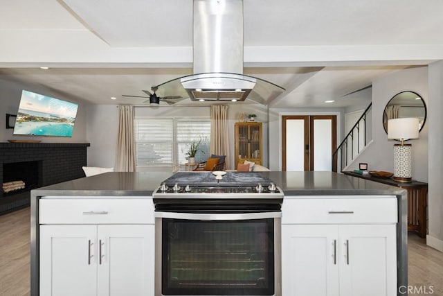 3314 Benton Ave, La Verne, CA 91750 - kitchen with stainless steel range, open floor plan, dark countertops, white cabinets, and light wood finished floors