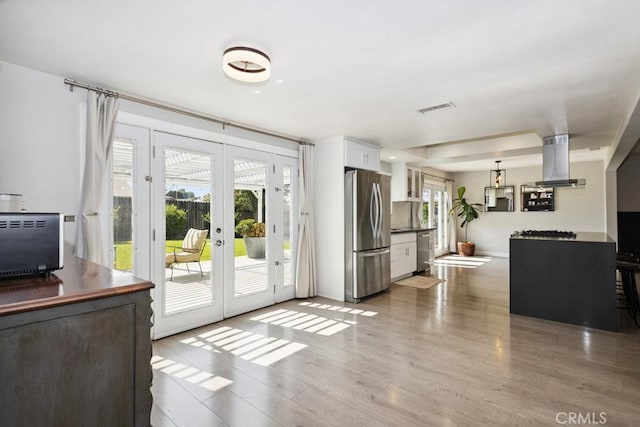 3314 Benton Ave, La Verne, CA 91750 - kitchen featuring appliances with stainless steel finishes, island range hood, healthy amount of natural light, and french doors