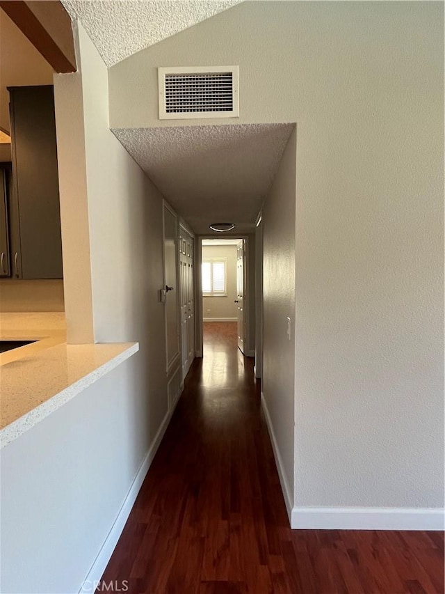 22 Country Mile Rd, Pomona, CA 91766 - hallway with a textured ceiling, dark wood-style floors, and lofted ceiling