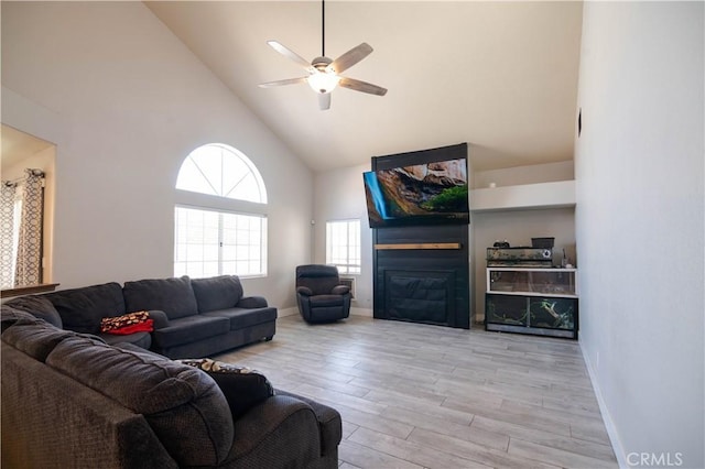 26511 Mainsail Ln, Helendale, CA 92342 - living room featuring high vaulted ceiling, a ceiling fan, wood finished floors, and a glass covered fireplace