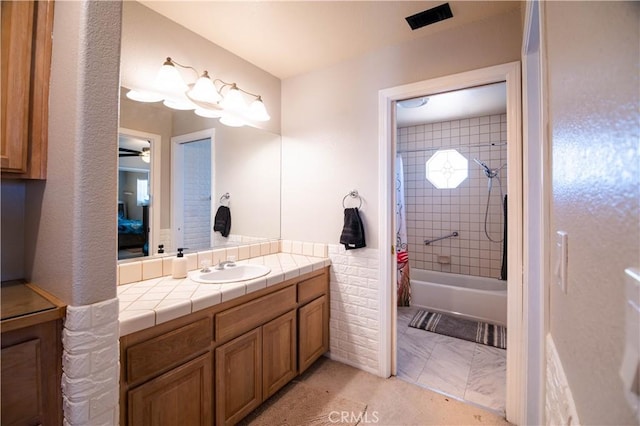 26511 Mainsail Ln, Helendale, CA 92342 - full bathroom with vanity, shower / tub combo with curtain, and ceiling fan