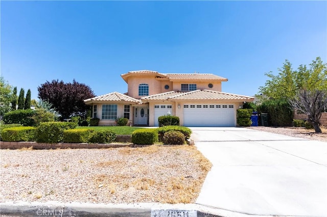 26511 Mainsail Ln, Helendale, CA 92342 - mediterranean / spanish-style home featuring an attached garage, a tiled roof, stucco siding, and concrete driveway