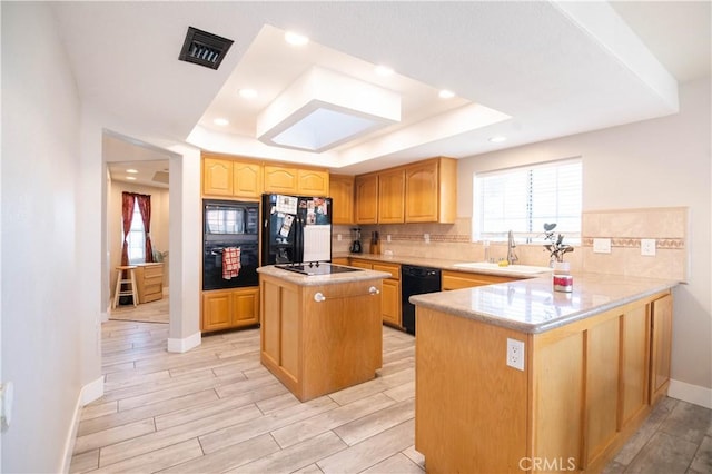 26511 Mainsail Ln, Helendale, CA 92342 - kitchen with black appliances, a tray ceiling, light countertops, healthy amount of natural light, and recessed lighting