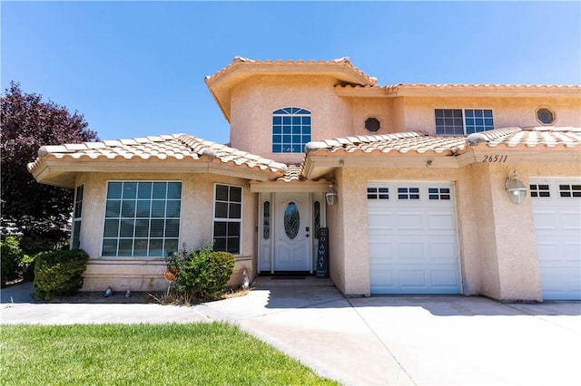 26511 Mainsail Ln, Helendale, CA 92342 - mediterranean / spanish home featuring stucco siding, a tiled roof, driveway, and a garage