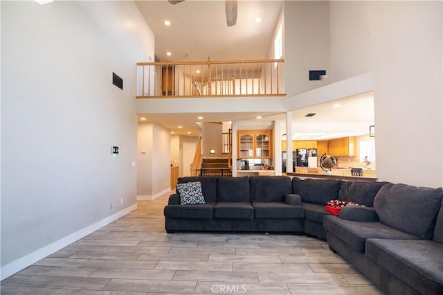 26511 Mainsail Ln, Helendale, CA 92342 - living room with a towering ceiling, light wood finished floors, stairs, and recessed lighting