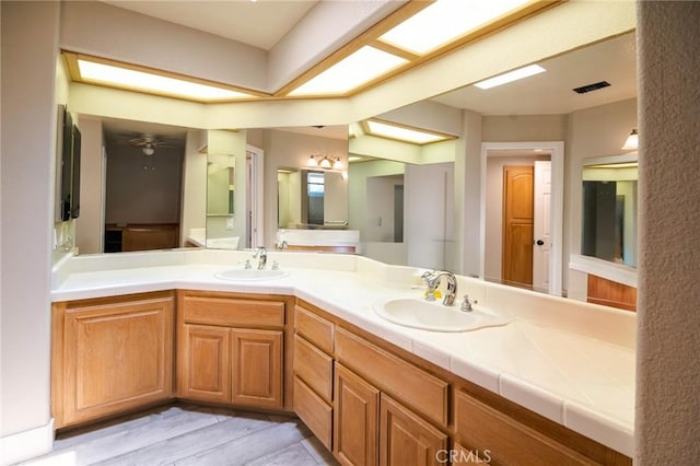 26511 Mainsail Ln, Helendale, CA 92342 - bathroom featuring double vanity and wood finished floors