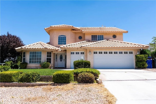 26511 Mainsail Ln, Helendale, CA 92342 - mediterranean / spanish house featuring driveway, an attached garage, stucco siding, and a tile roof