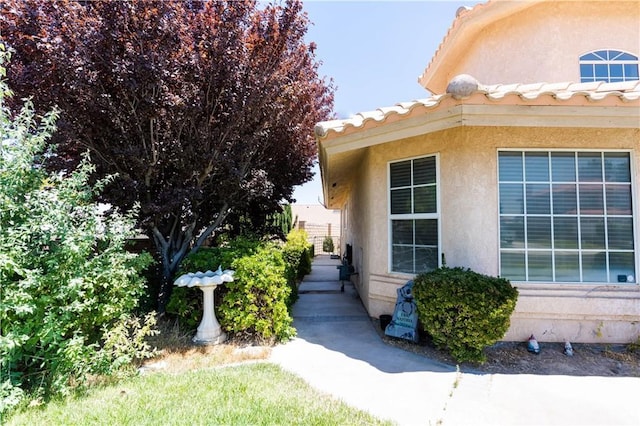 26511 Mainsail Ln, Helendale, CA 92342 - view of exterior entry with stucco siding and a tiled roof