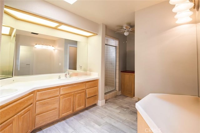 26511 Mainsail Ln, Helendale, CA 92342 - full bathroom with a stall shower, double vanity, a ceiling fan, and wood finished floors