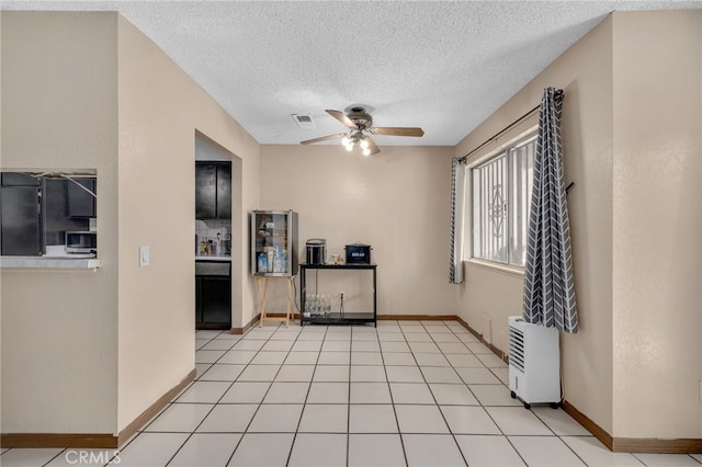 11286 Parkside Ln Unit 22, Garden Grove, CA 92843 - kitchen with ceiling fan, a textured ceiling, stainless steel microwave, and refrigerator