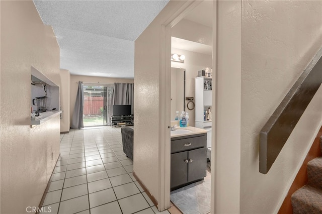 11286 Parkside Ln Unit 22, Garden Grove, CA 92843 - hall with a textured wall, light tile patterned floors, a textured ceiling, and stairway
