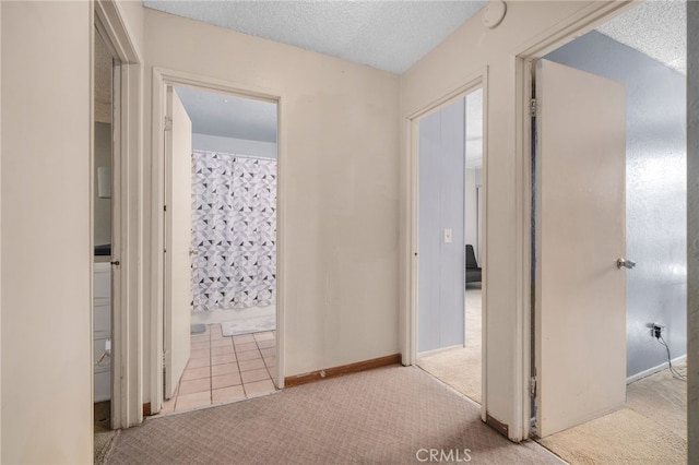 11286 Parkside Ln Unit 22, Garden Grove, CA 92843 - hallway featuring carpet flooring, a textured ceiling, and tile patterned flooring