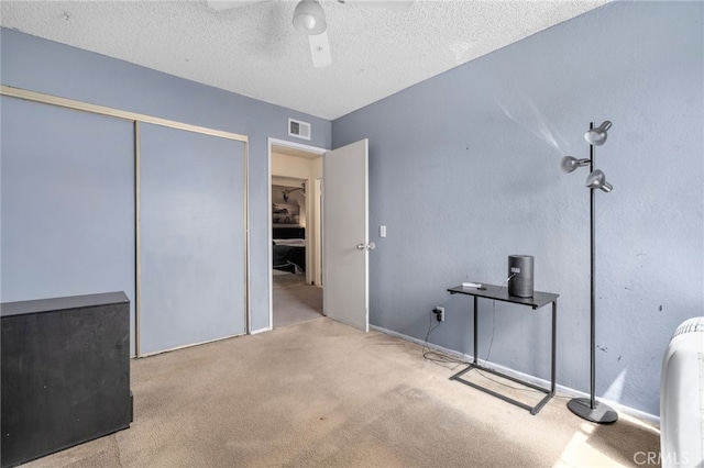 11286 Parkside Ln Unit 22, Garden Grove, CA 92843 - unfurnished bedroom featuring carpet flooring, a textured ceiling, a ceiling fan, and a closet