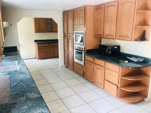 2710 Castle Rock Rd, Diamond Bar, CA 91765 - kitchen featuring open shelves, stainless steel appliances, and light tile patterned floors