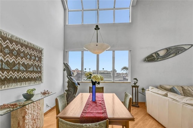 16745 Bayview Dr Unit B, Sunset Beach, CA 90742 - dining room with a high ceiling, light wood-type flooring, and plenty of natural light
