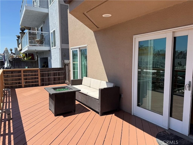 16745 Bayview Dr Unit B, Sunset Beach, CA 90742 - wooden deck with an outdoor living space with a fire pit